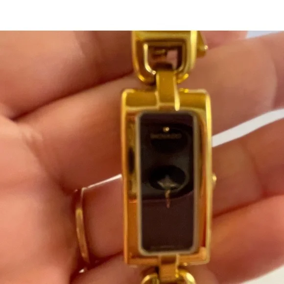 Like New!! Movado rectangle black dial with yellow gold bracelet watch. Movado Moda Yellow Gold PVD and Black Ceramic Bangle  main image 2